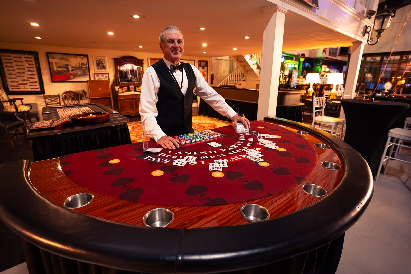 Dealer in a vest at a blackjack table inside a private event venue