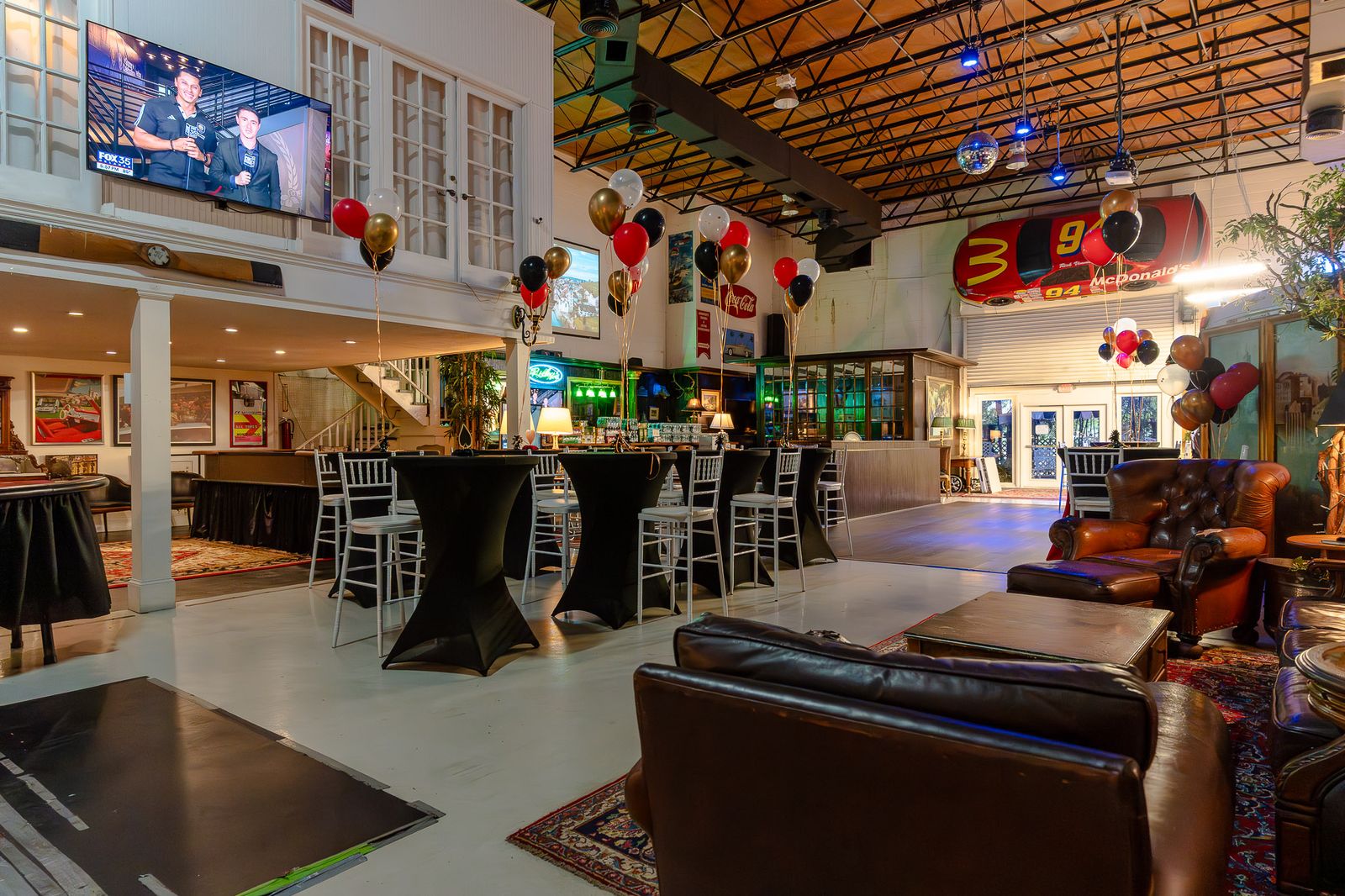 Wide view of a decorated private event venue with bars and seating
